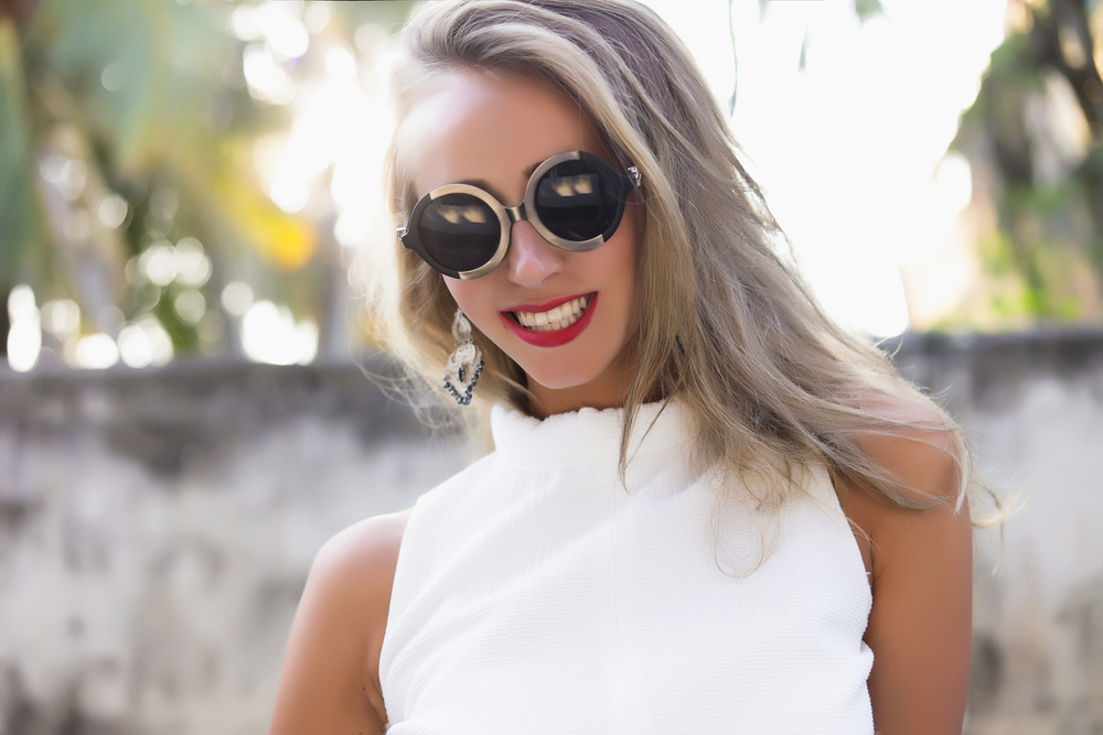 Violet-Silver Ash Blonde, one of the best hair colors for summer, pictured on a woman in sunglasses