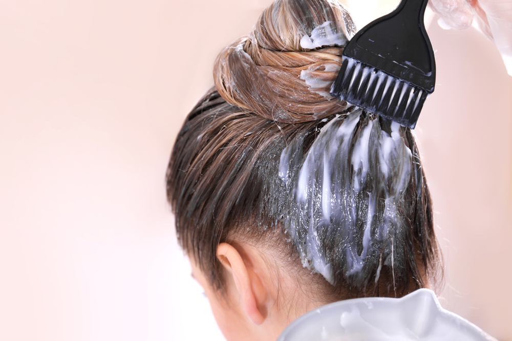 Woman getting her dark hair lightened in stages