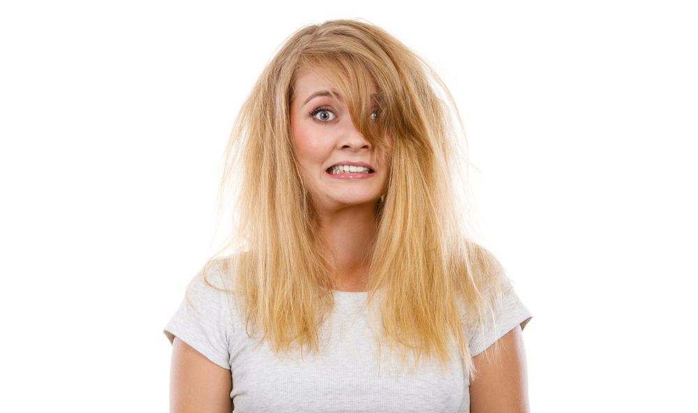 Woman panicking and wondering what does brassy hair look like after getting a bad bleach job
