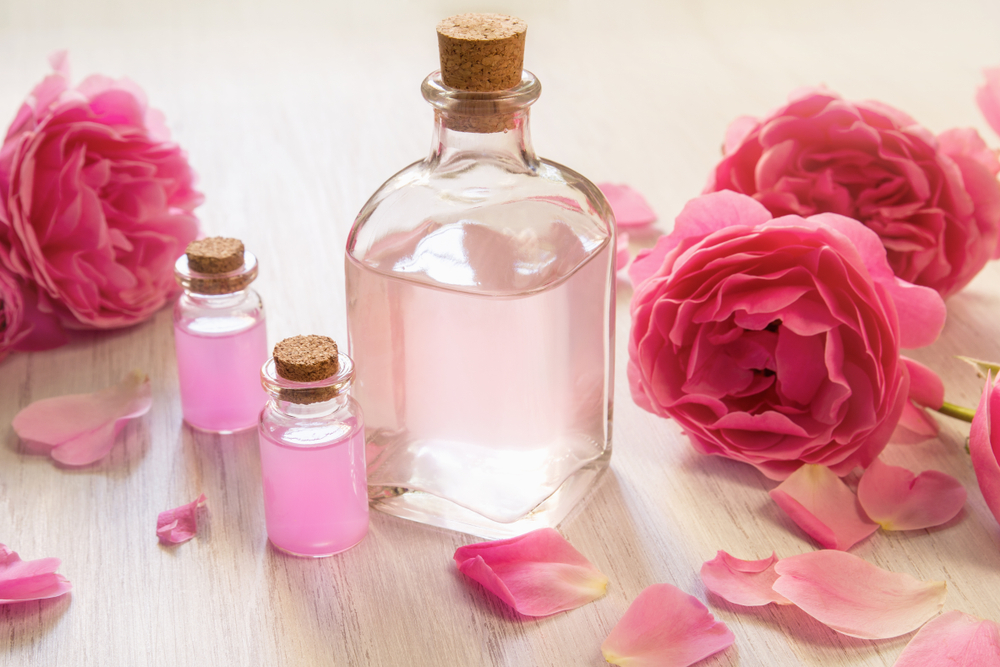 Image of rose water being used for dreadlocks on a table in a jar