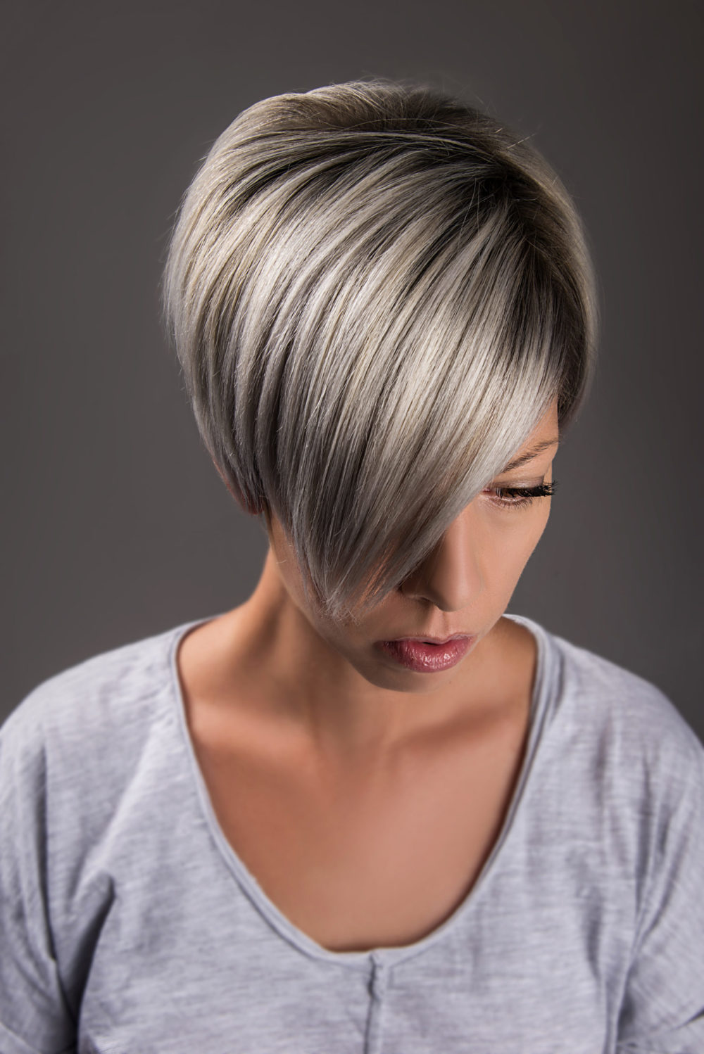 Smudged Root Pixie With Long Bangs, a great trendy short grey hairstyle