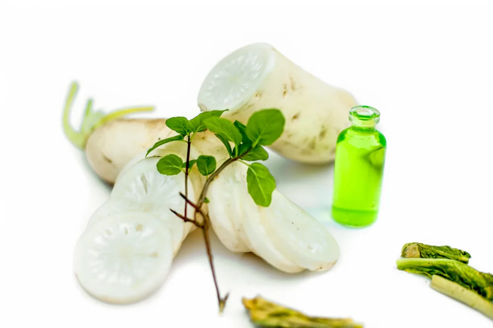Daikon seed extract pictured on a table for a piece on is dimethicone bad for your hair