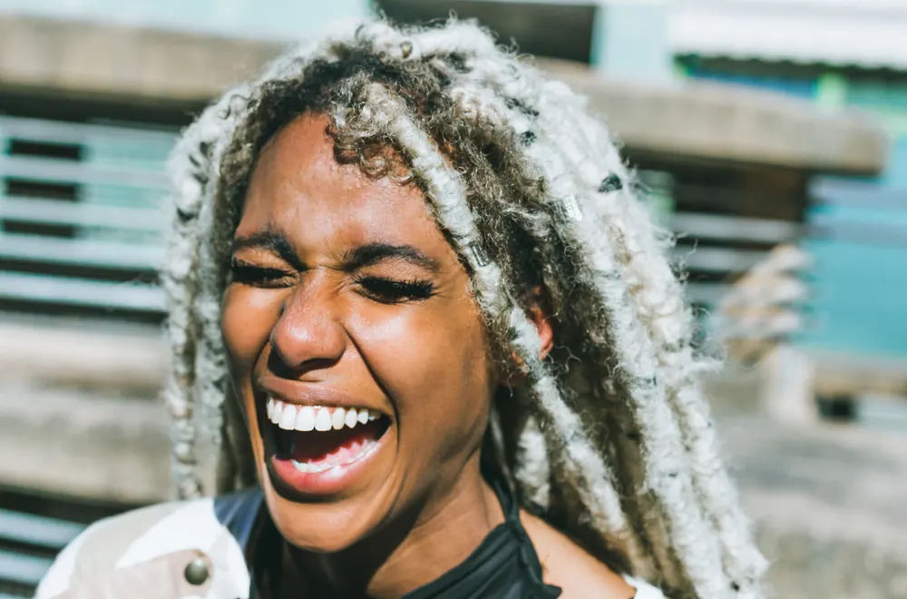 Woman smiling and wondering are dreadlocks dirty