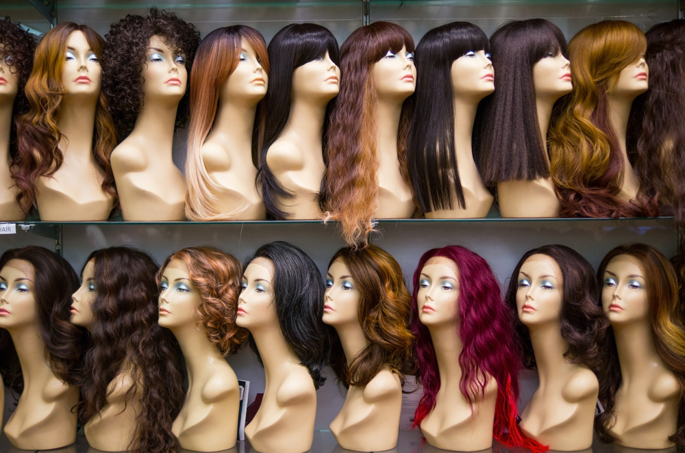 Black woman relaxer hairstyles featuring wigs on mannequin heads