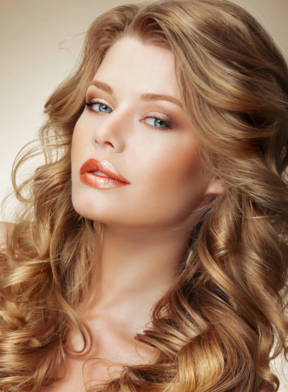 Medium Butterscotch Blonde hair color on a woman with pale skin and red lip