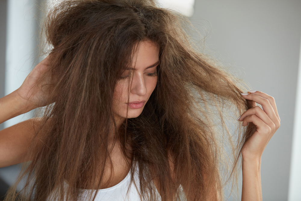 Image of a woman wondering how to get a rat's nest out of hair