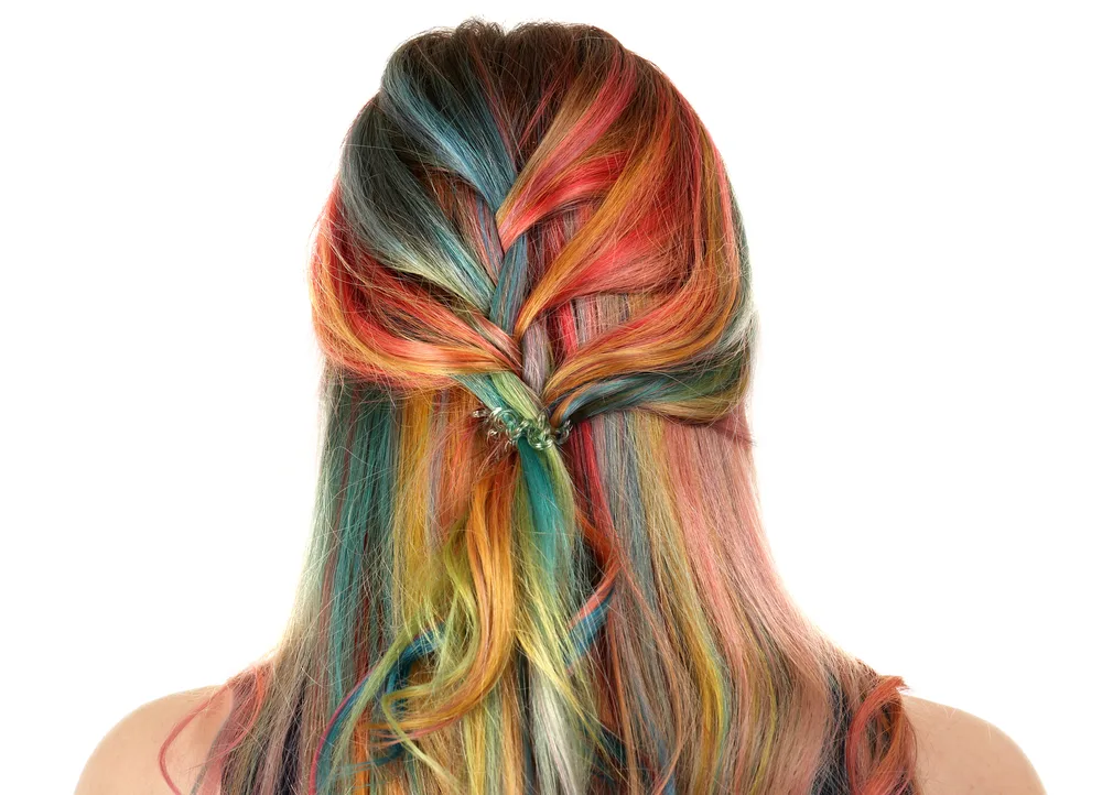 For a piece on Bohemian Briads, a picture of a woman with Loosened Half-Up Rainbow French Braid