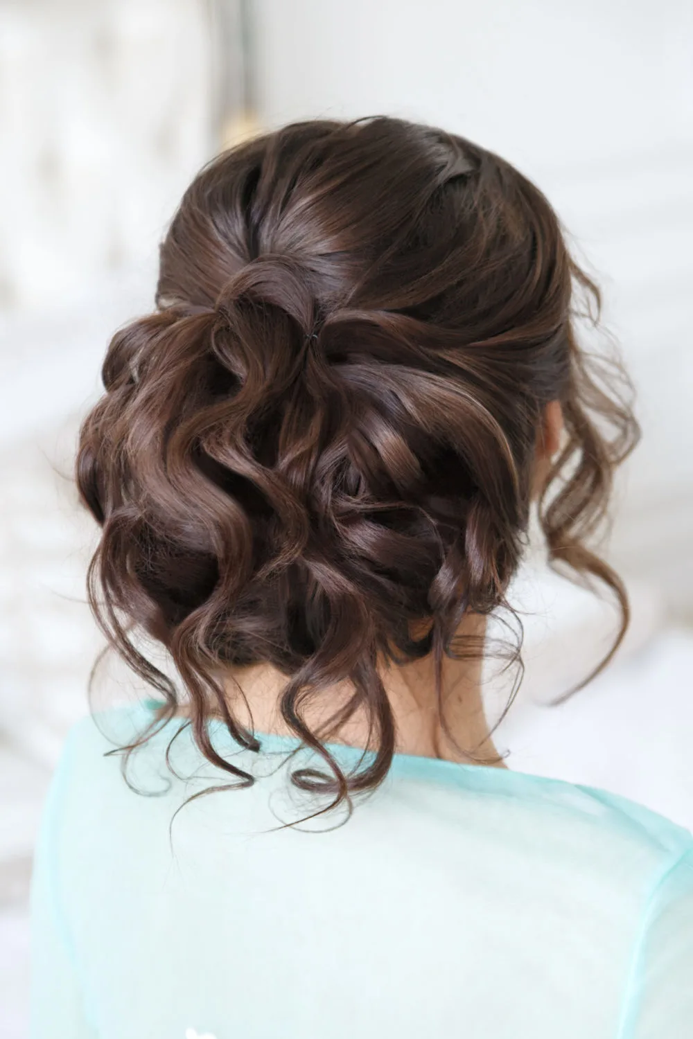 Formal Curled Bun With Loose Pieces for a piece on mother of the bride hairstyles
