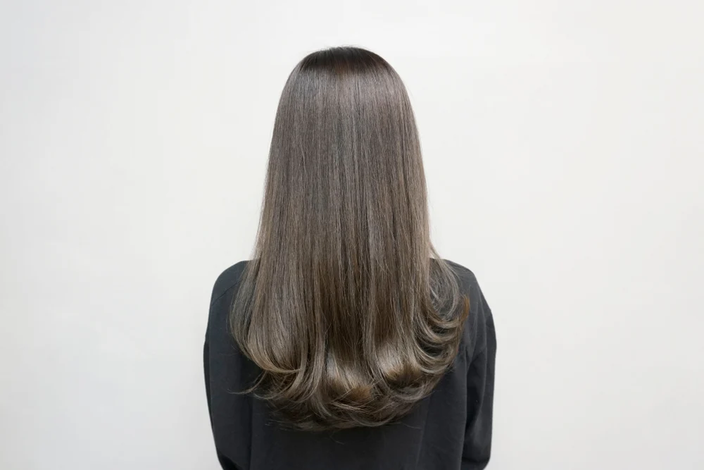As a roundup for highlights for brown hair, a woman wears Dark Mushroom Brown With Medium Ash Balayage