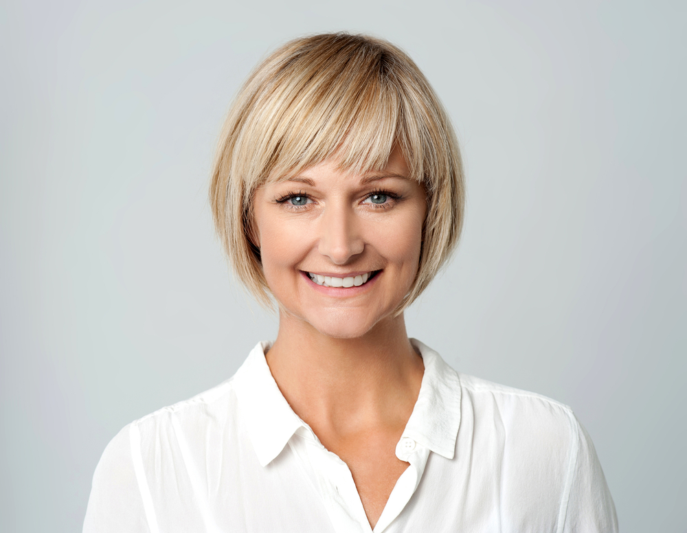 Sleek Rounded Bob With Layered Bangs, a short haircut for square faced women
