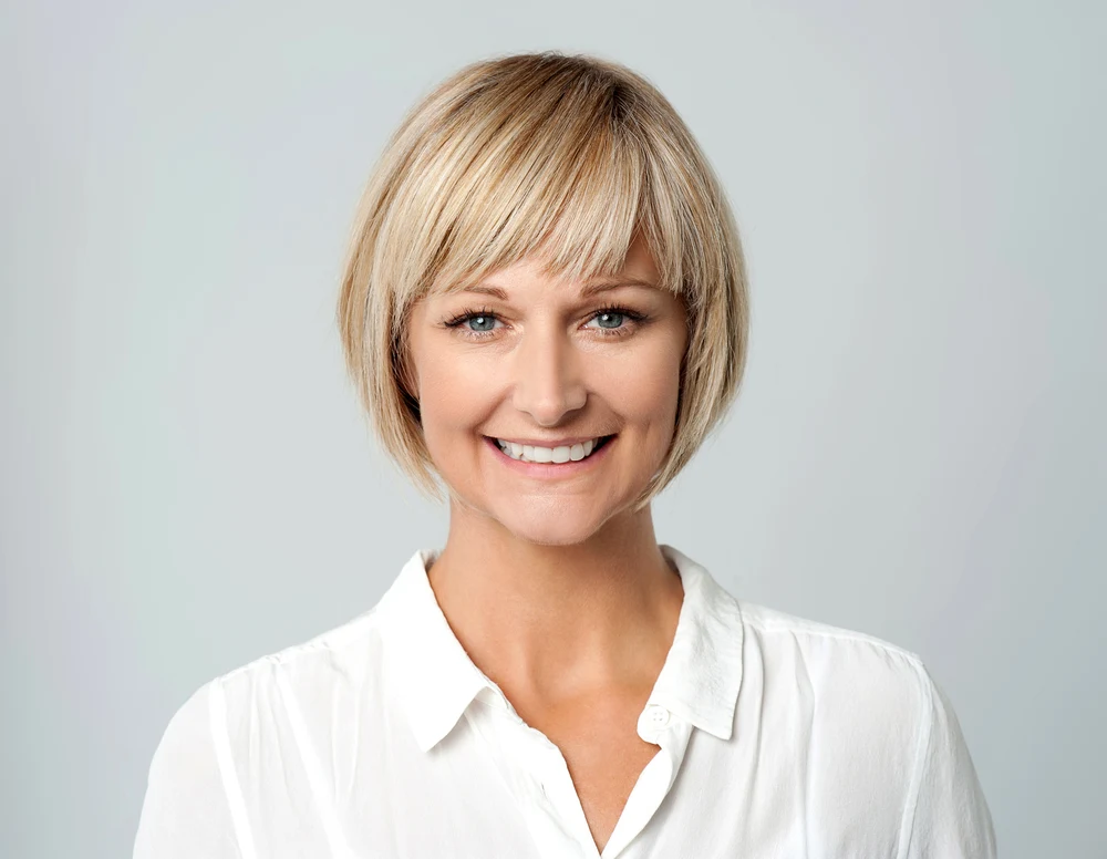 Sleek Rounded Bob With Layered Bangs, a short haircut for square faced women
