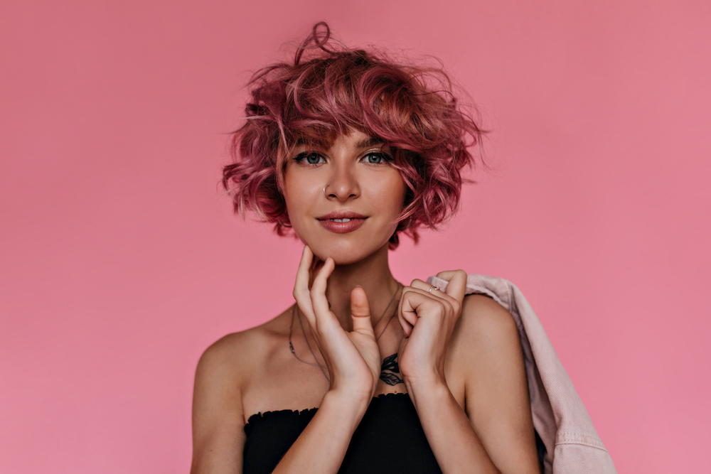 Tapered Curly Bob With Full Bangs, a featured short haircut for thick hair