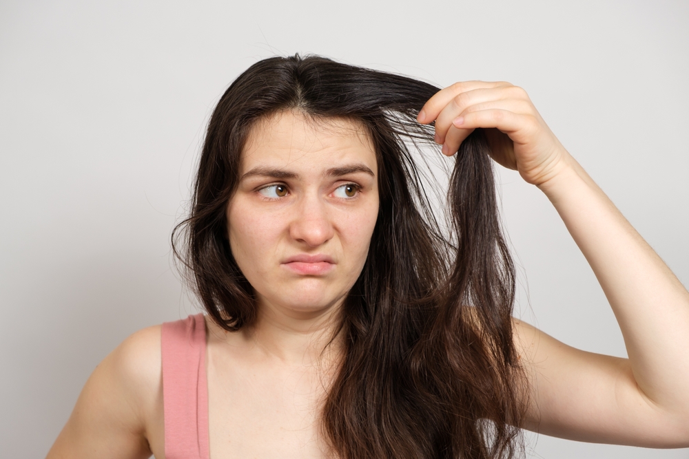 Woman wondering why she has so much sebum in her hair