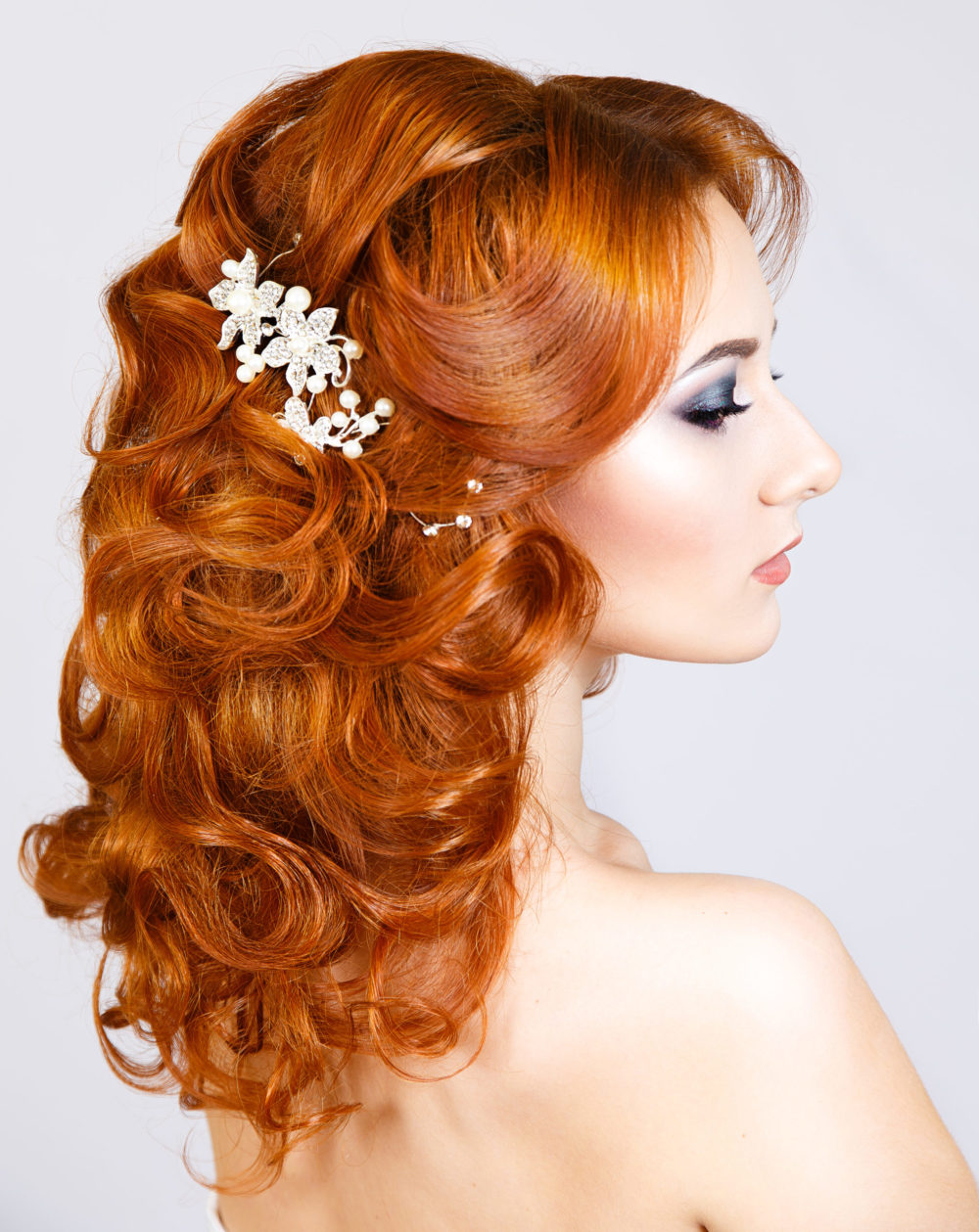 Curly Partial Half-Updo With Barrette for a piece on gorgeous prom hairstyles