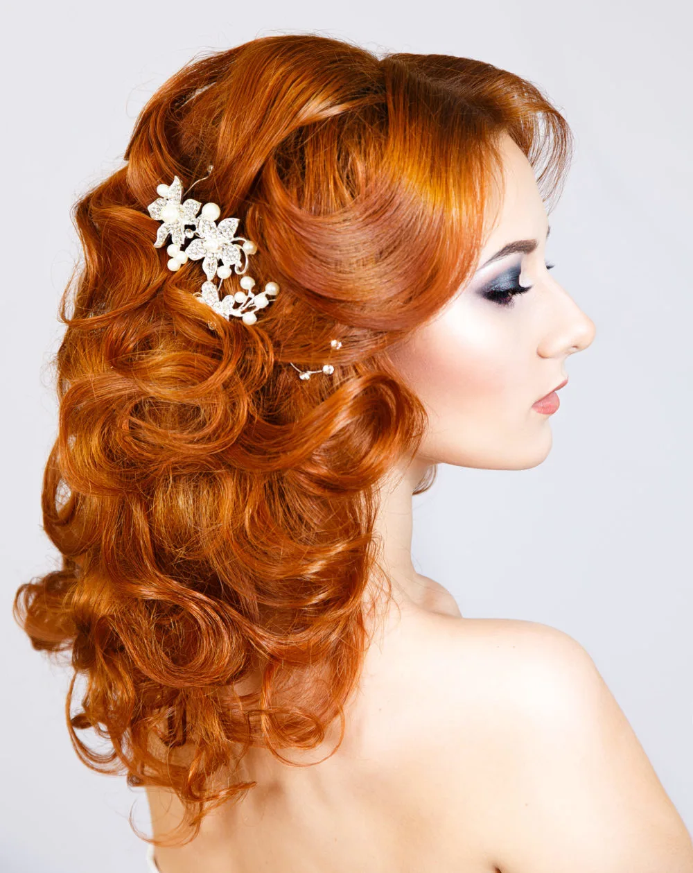 Curly Partial Half-Updo With Barrette for a piece on gorgeous prom hairstyles