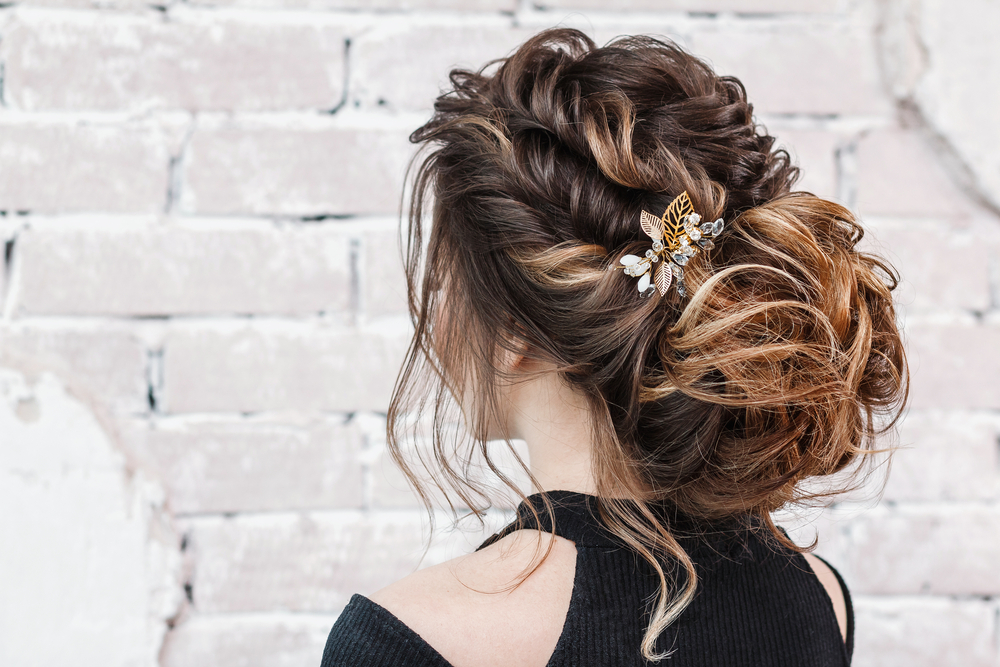 Low Tousled Bun With Loose Twists, one of the best prom hairstyles to wear this year