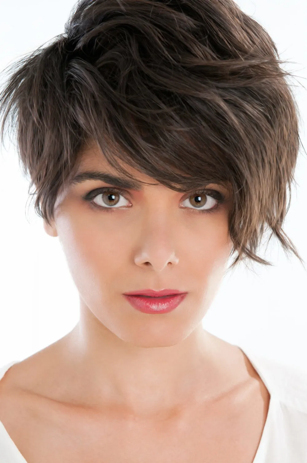 For a piece on the best short haircuts for thick hair, a woman wears a cut titled Top-Heavy Layered Pixie Cut