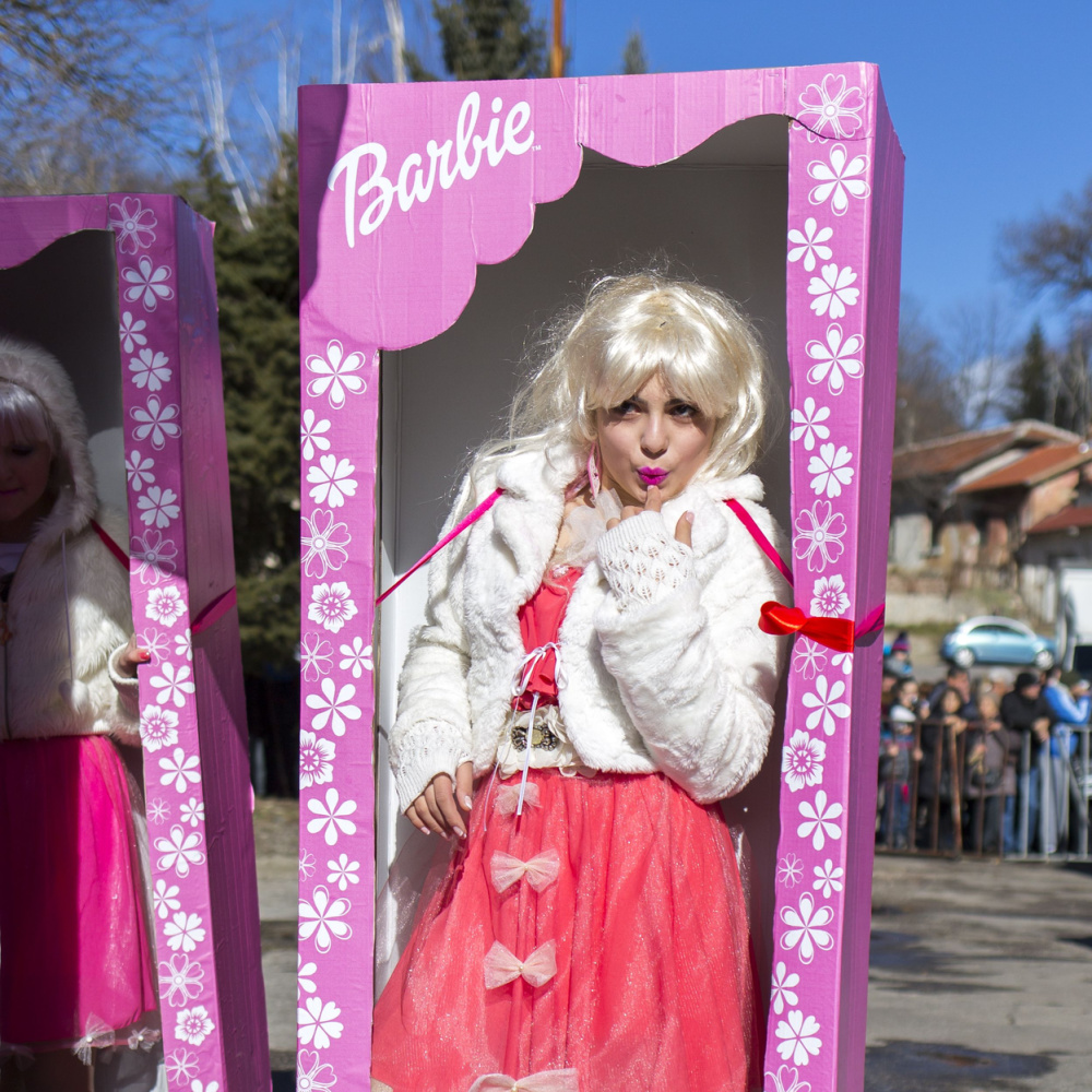 Woman in one of the best Halloween costumes for blondes as Barbie in a box