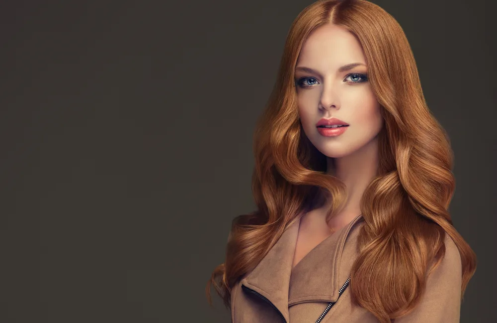 Fair-skinned woman with Warm Medium Copper, one of the best hair colors for grey eyes