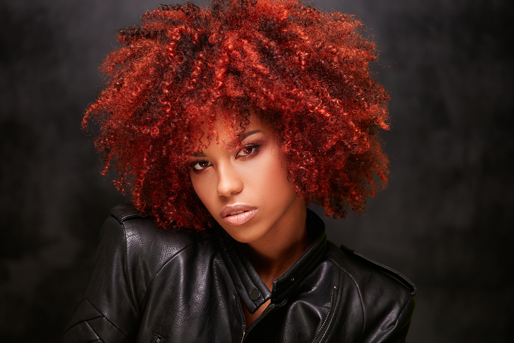 Bright Multi-Toned Carnelian hair on a black woman in a leather jacket