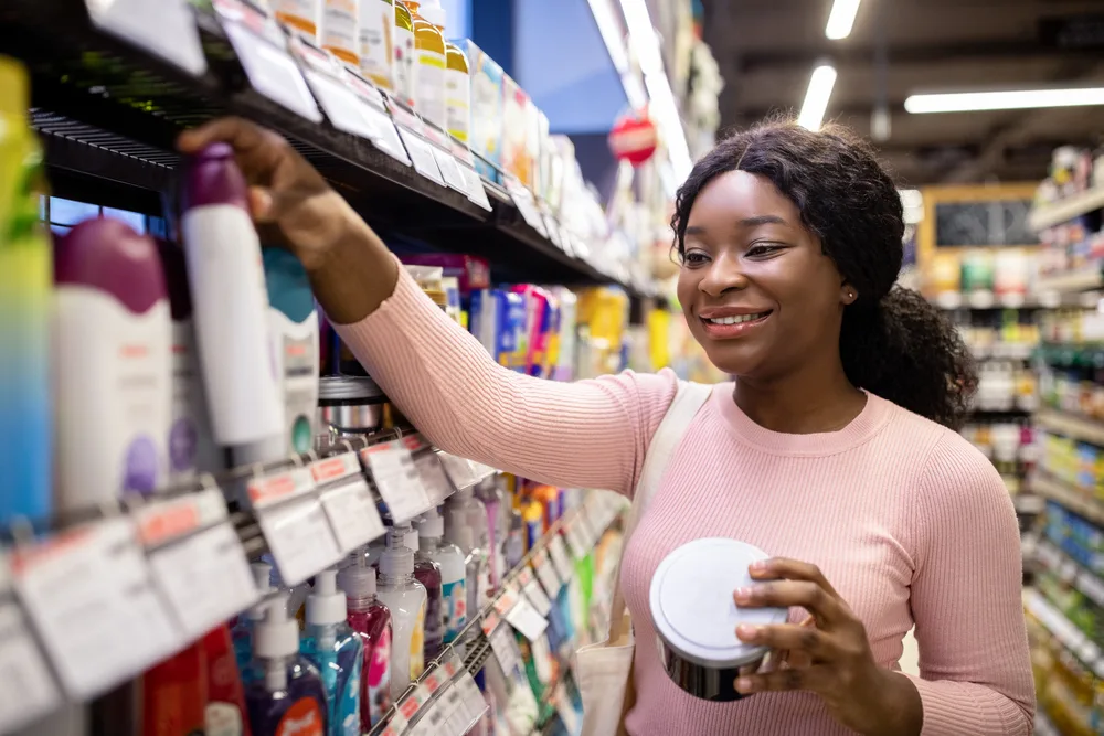 Woman shopping in a store for the best shampoo and conditioner for black hair growth