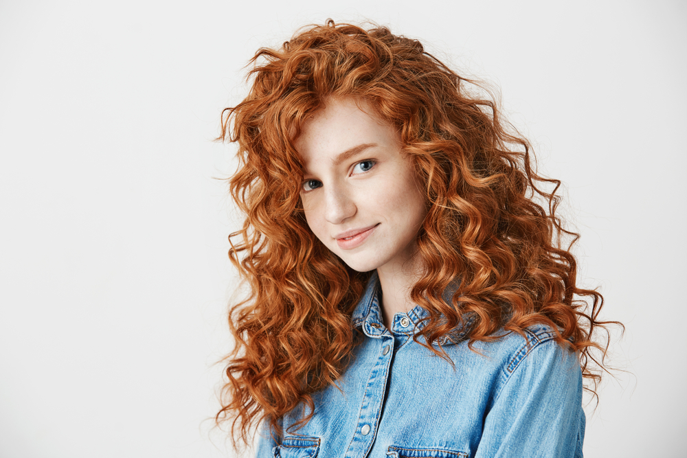 Image of a woman with Fiery light Copper hair, one of the best hair colors for curly hair