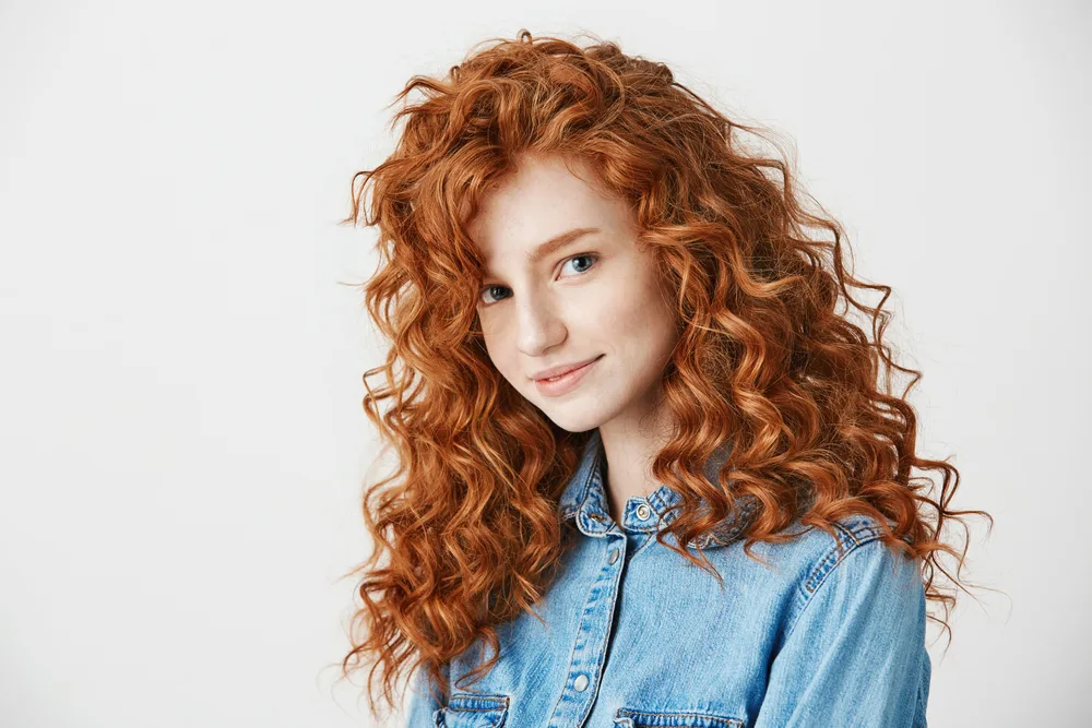 Image of a woman with Fiery light Copper hair, one of the best hair colors for curly hair