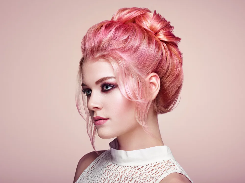 Light Coral and Pink Lemonade colored hair on a woman with a doll's complexion skin