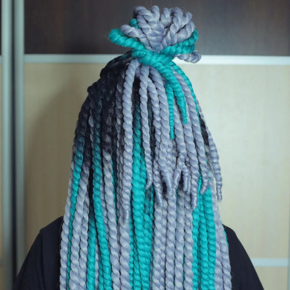 Multi-colored spring twists seen from the back in a half up top knot hairstyle