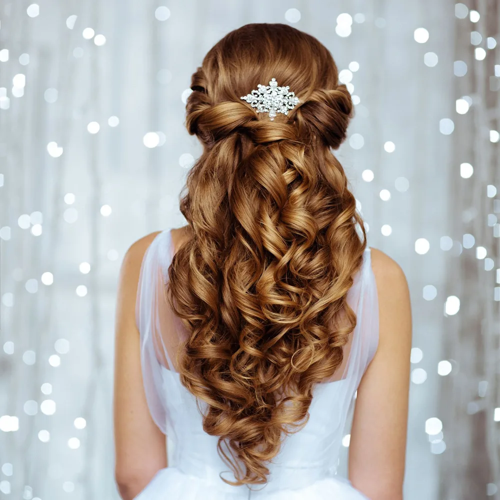 Girl with copper red hair wears one of the best half up prom hairstyles with twists and curls alongside a white dress