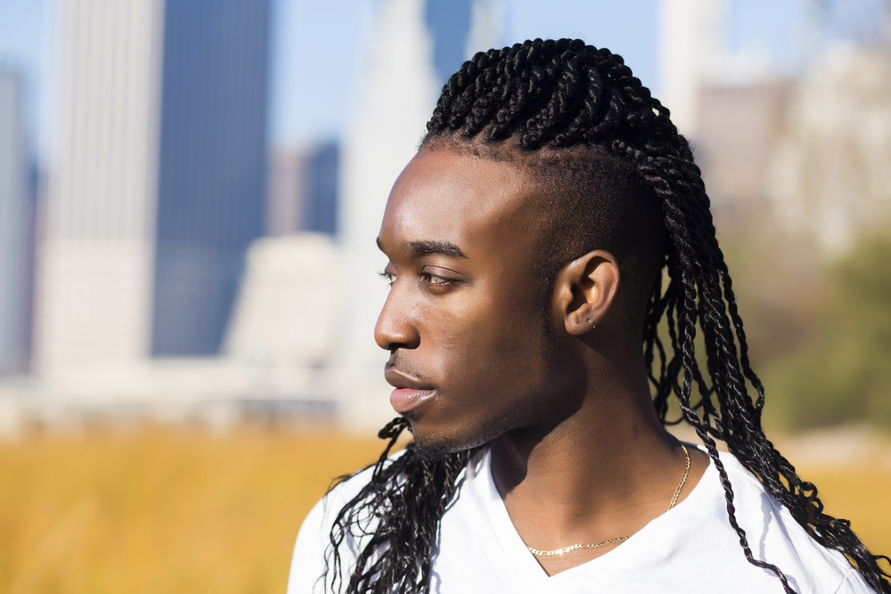 African American man wears spring twist hair in a pompadour undercut style