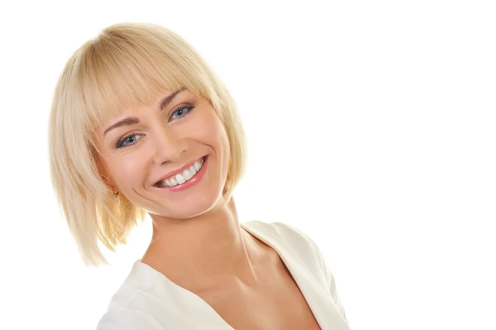 Softly Layered Wheat Blonde Bob With Blunt Bangs for a roundup of women with short blonde hair